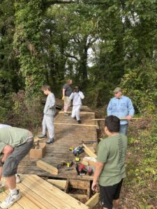 Volunteers building a boardwalk through the woods