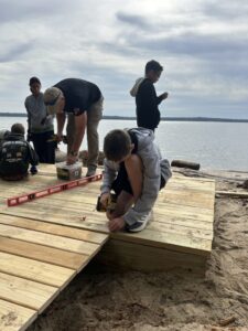 Volunteers building a deck at the water’s edge